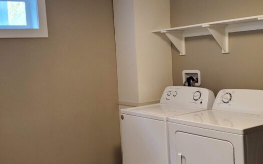 Living area in a bright Glenmore two bedroom suite listing
